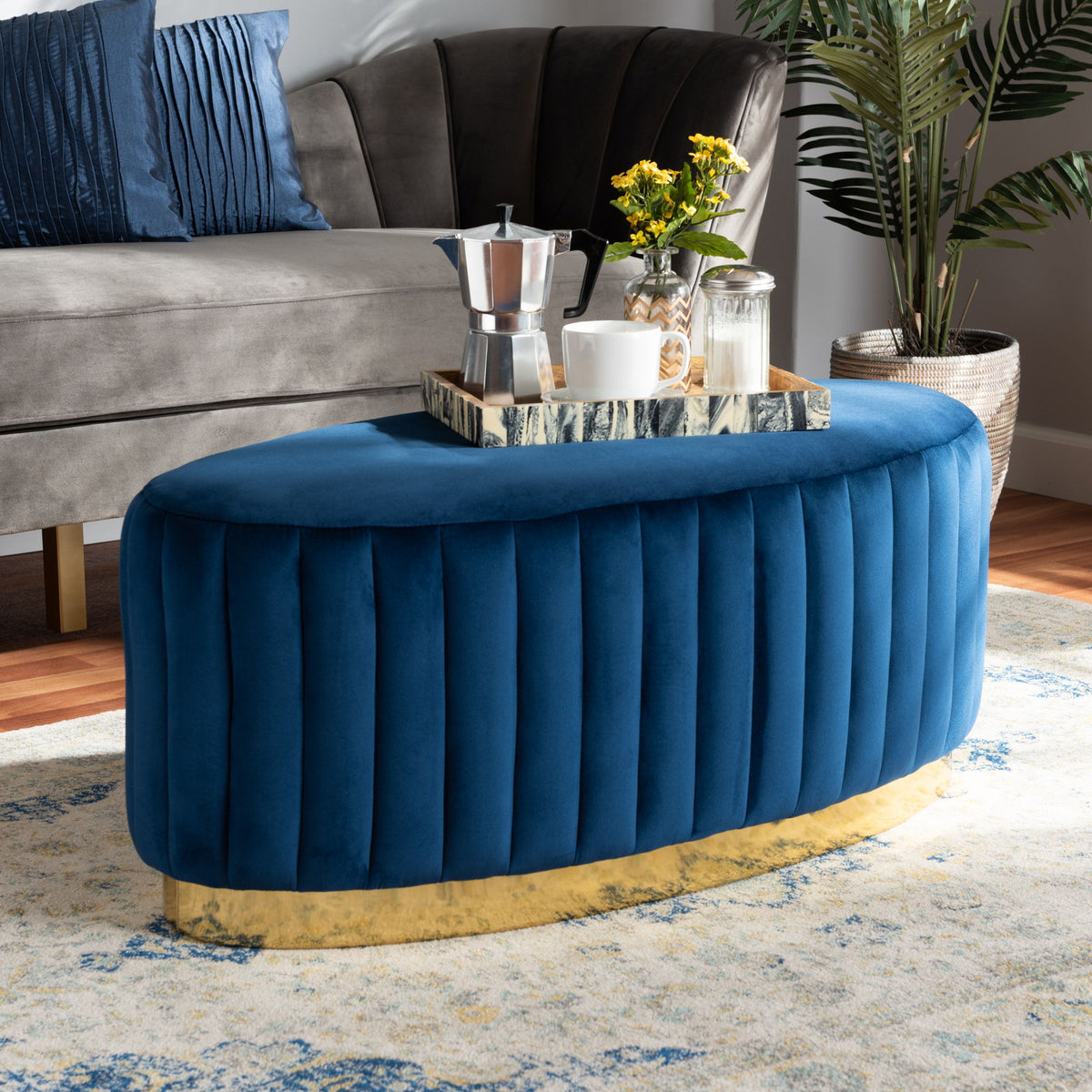 Kirana Glam and Luxe Navy Blue Velvet Fabric Upholstered and Gold PU Leather Ottoman