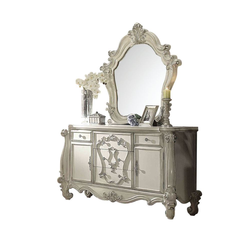 ACME The Versailles mirror gives your bedroom all the grandeur of royal style. This mirror has a substantial silhouette and is adorned with such old-world details, carved medallions, and shaped moldings. This mirror is the perfect addition to any bedroom.