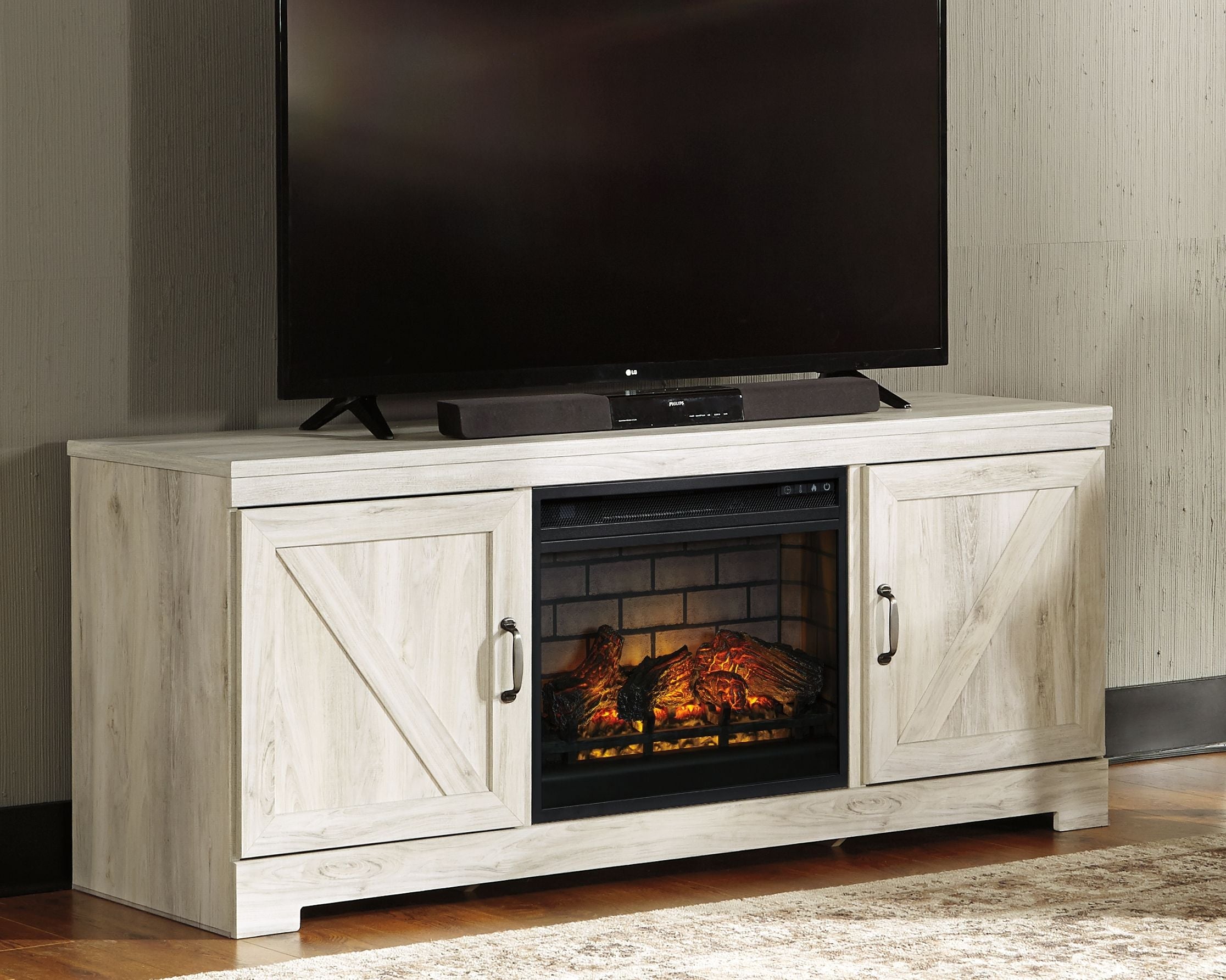 Signature Design by Ashley® Bellaby - Whitewash - 63" TV Stand With Faux Firebrick Fireplace Insert | Meri Furniture