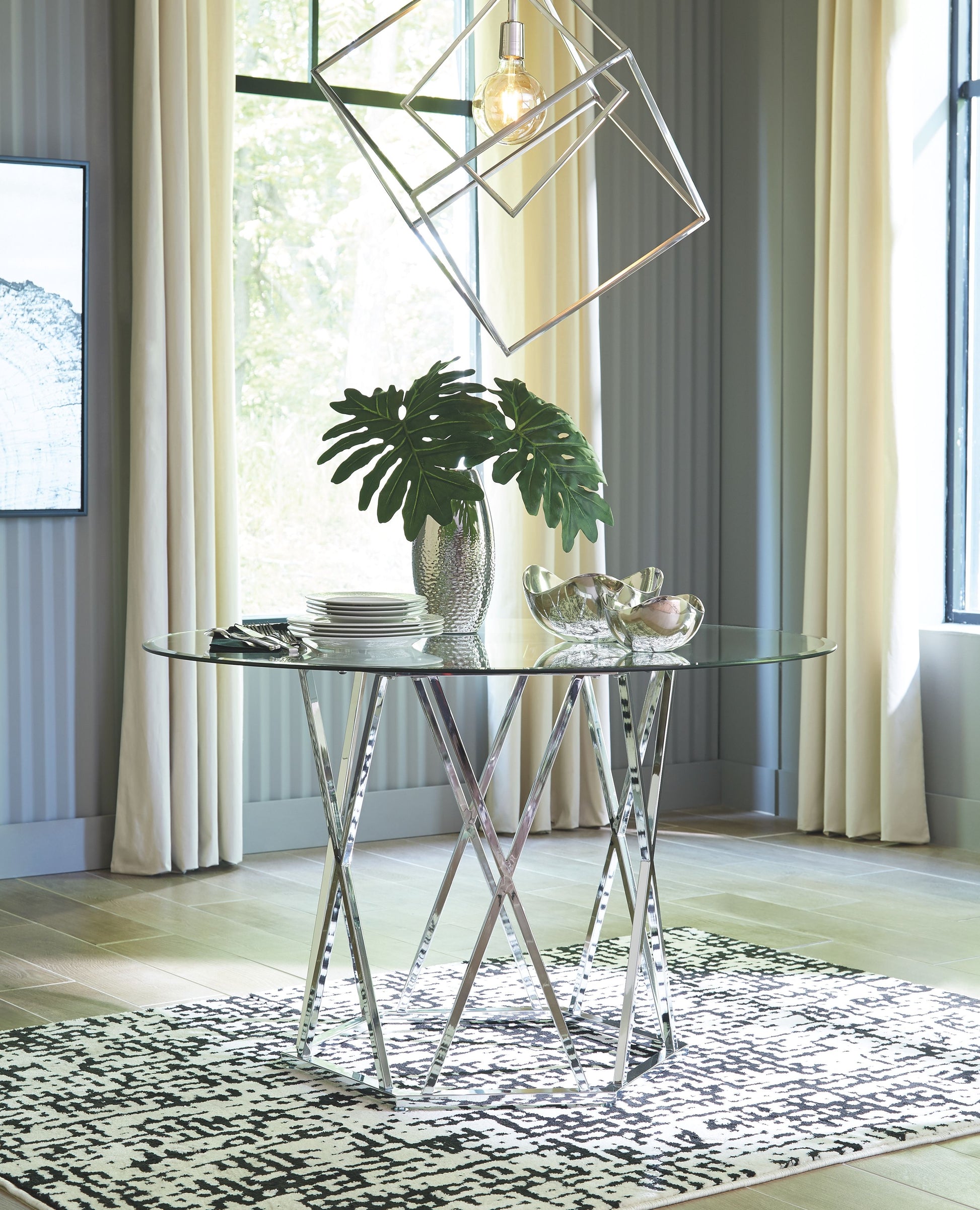 Signature Design by Ashley® Madanere - Chrome Finish - Round Dining Room Table | Meri Furniture