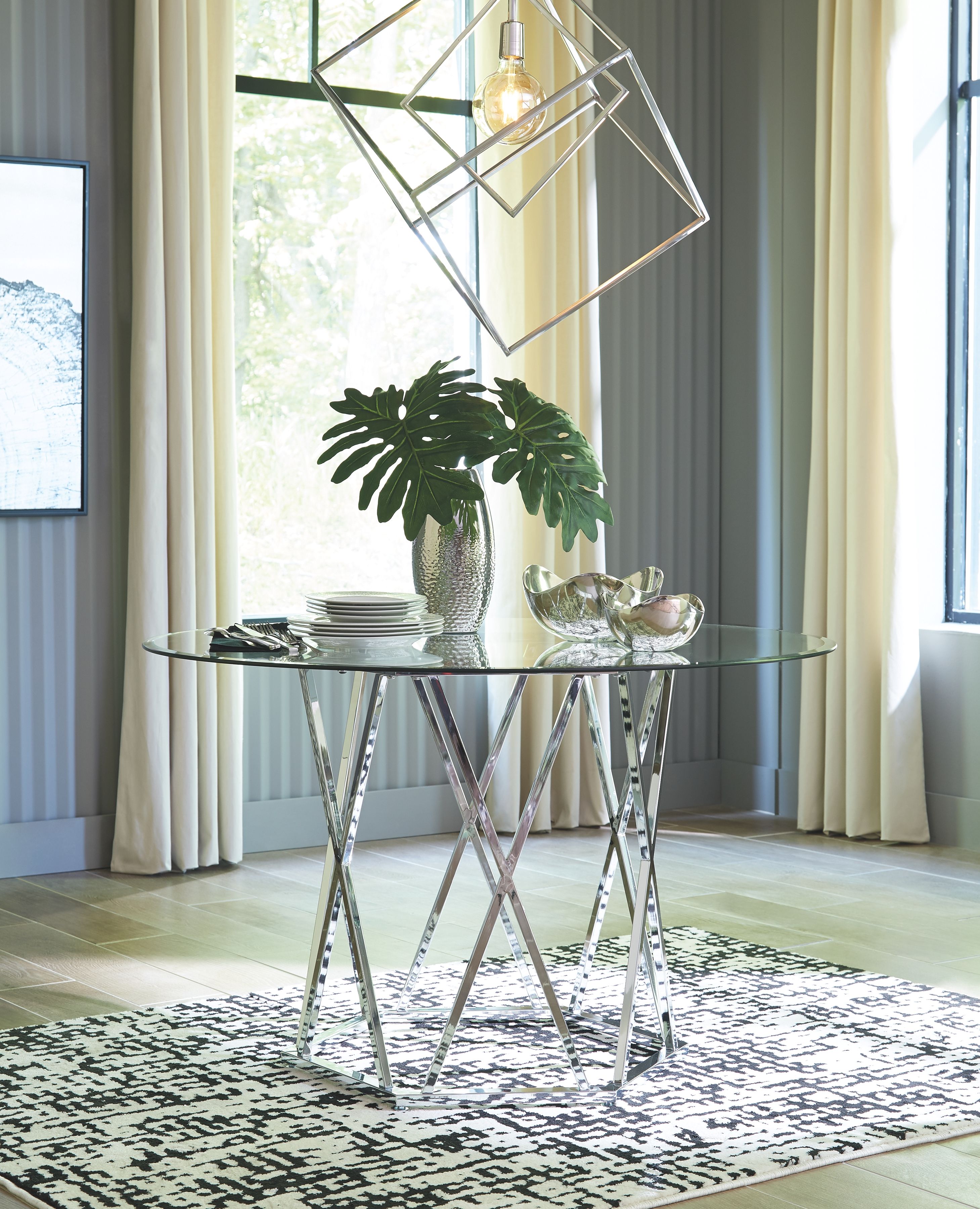 Signature Design by Ashley® Madanere - Chrome Finish - Round Dining Room Table | Meri Furniture