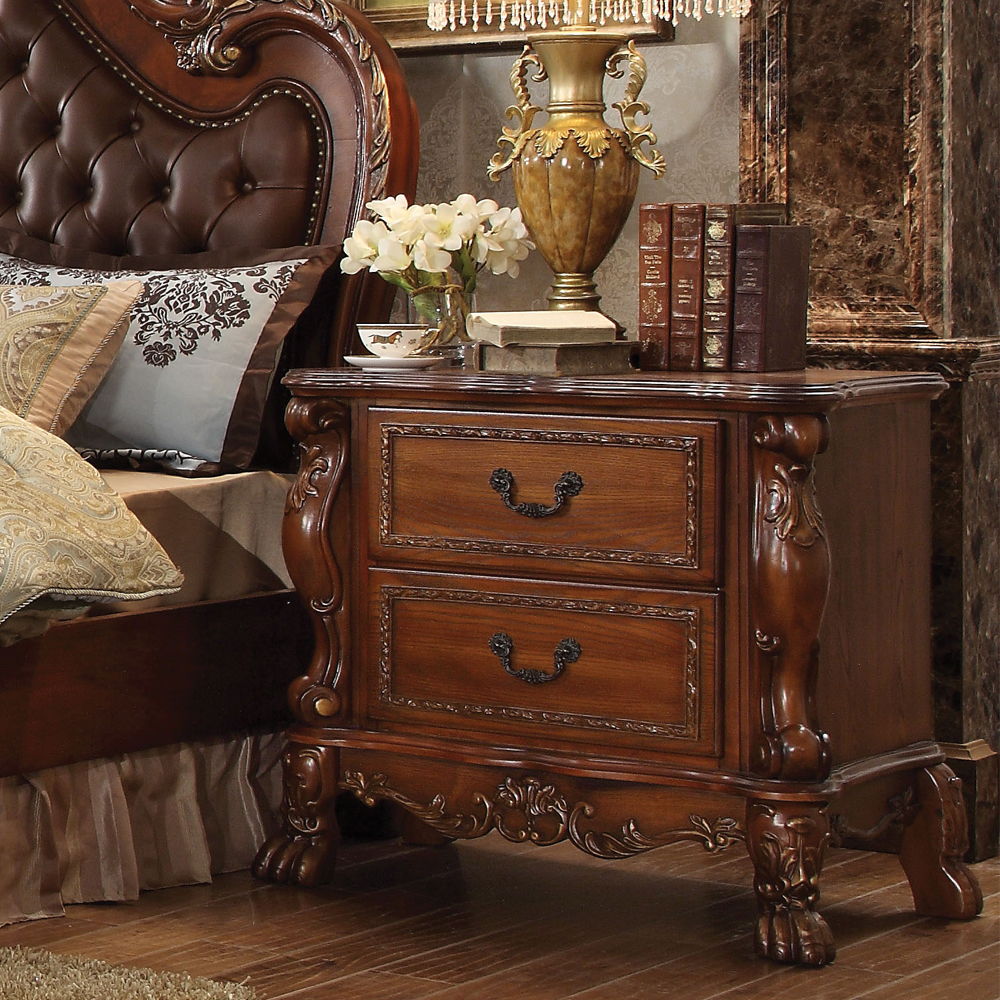 ACME The Dresden Nightstand offers beautiful craftsmanship and artistic carvings. It features solid hardwood with two drawers for storage with coordinating carvings. The drawers feature dove tail construction and are decorated with antique brass hardware.