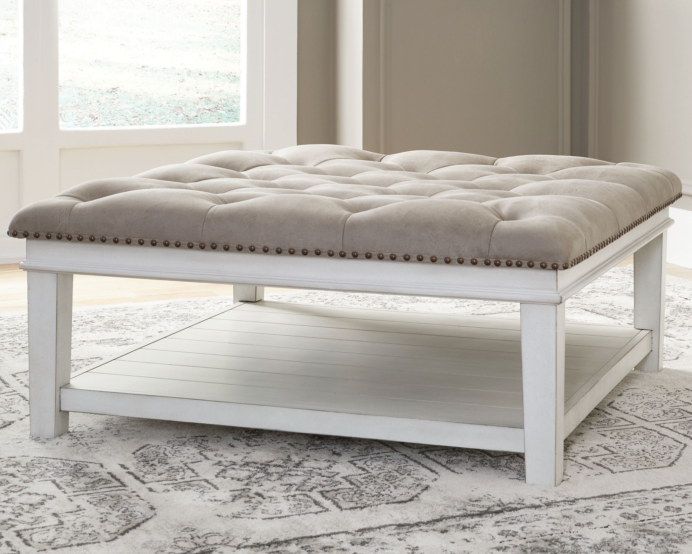 Signature Design by Ashley® Kanwyn - Whitewash - Uph Ottoman Cocktail Table | Meri Furniture