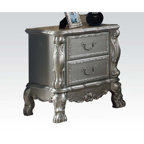 The Dresden Nightstand offers beautiful craftsmanship and artistic carvings. It features solid hardwood with two drawers for storage with coordinating carvings. The drawers feature dove tail construction and are decorated with antique brass hardware.