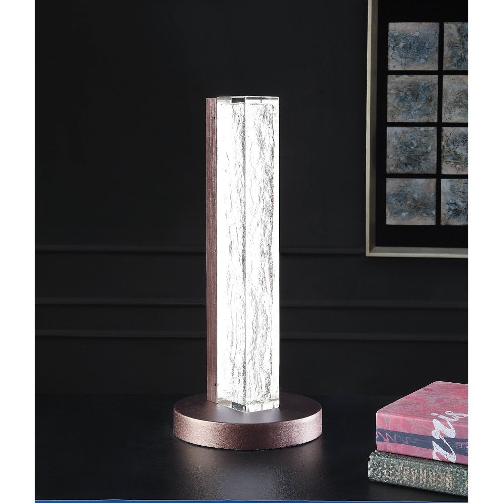 ACME Both a source of light and a beautiful accent piece, this clear resin lamp is not to be missed. The rectangular resin block of the lamp body leans modern, while the sleek finish of the metal base lends glamour to the overall design of this unique lam