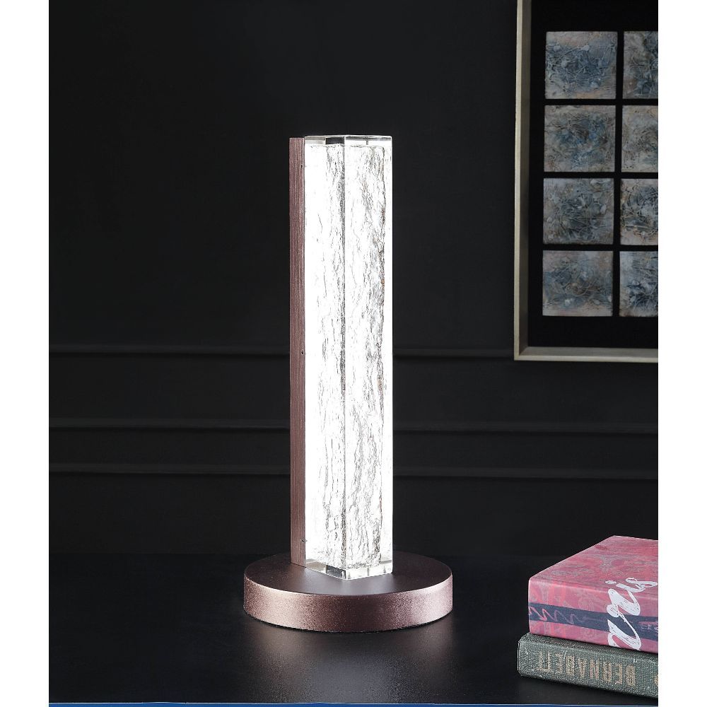 Both a source of light and a beautiful accent piece, this clear resin lamp is not to be missed. The rectangular resin block of the lamp body leans modern, while the sleek finish of the metal base lends glamour to the overall design of this unique lamp.