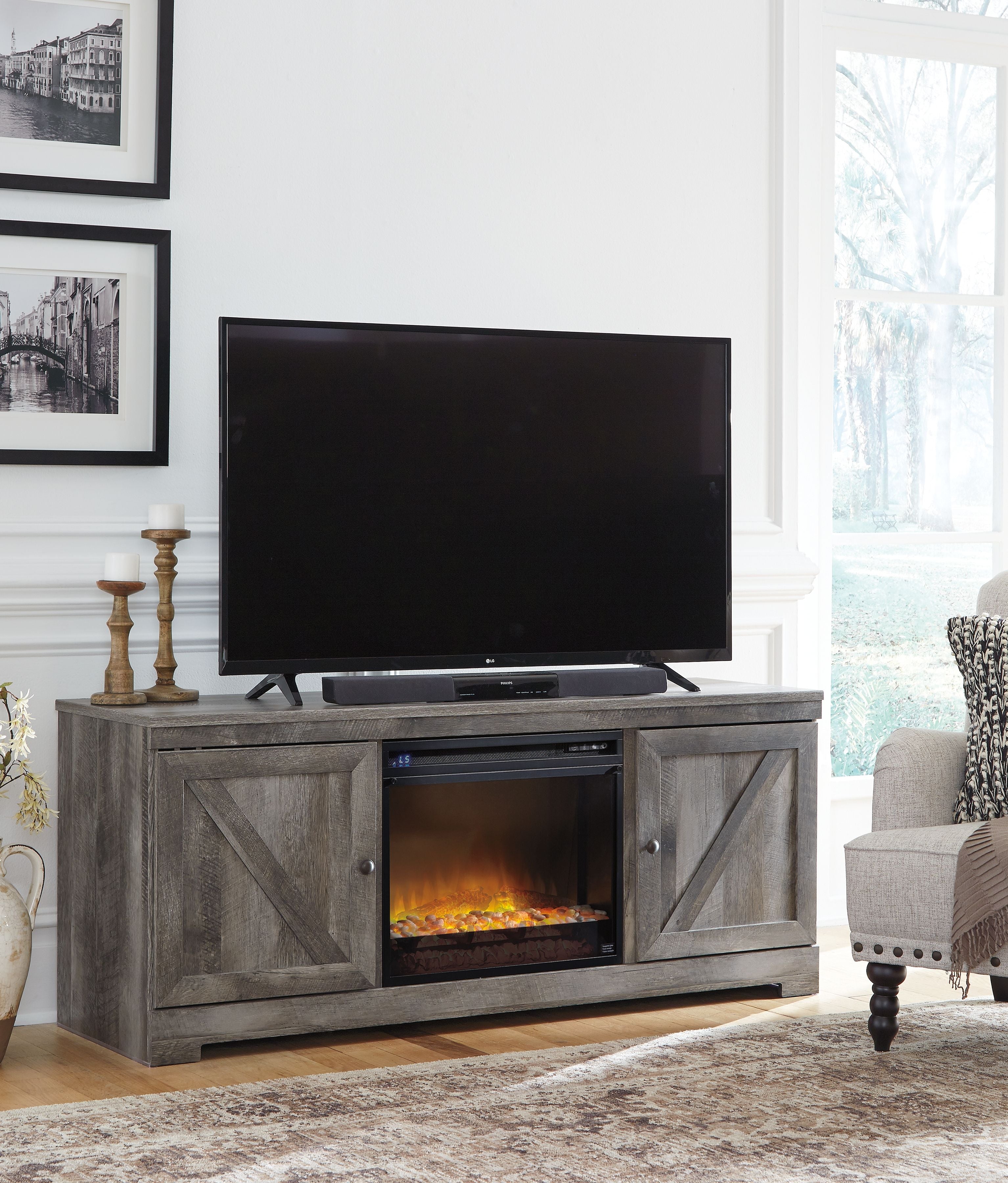 Signature Design by Ashley® Wynnlow - Gray - 63" TV Stand With Glass/Stone Fireplace Insert | Meri Furniture