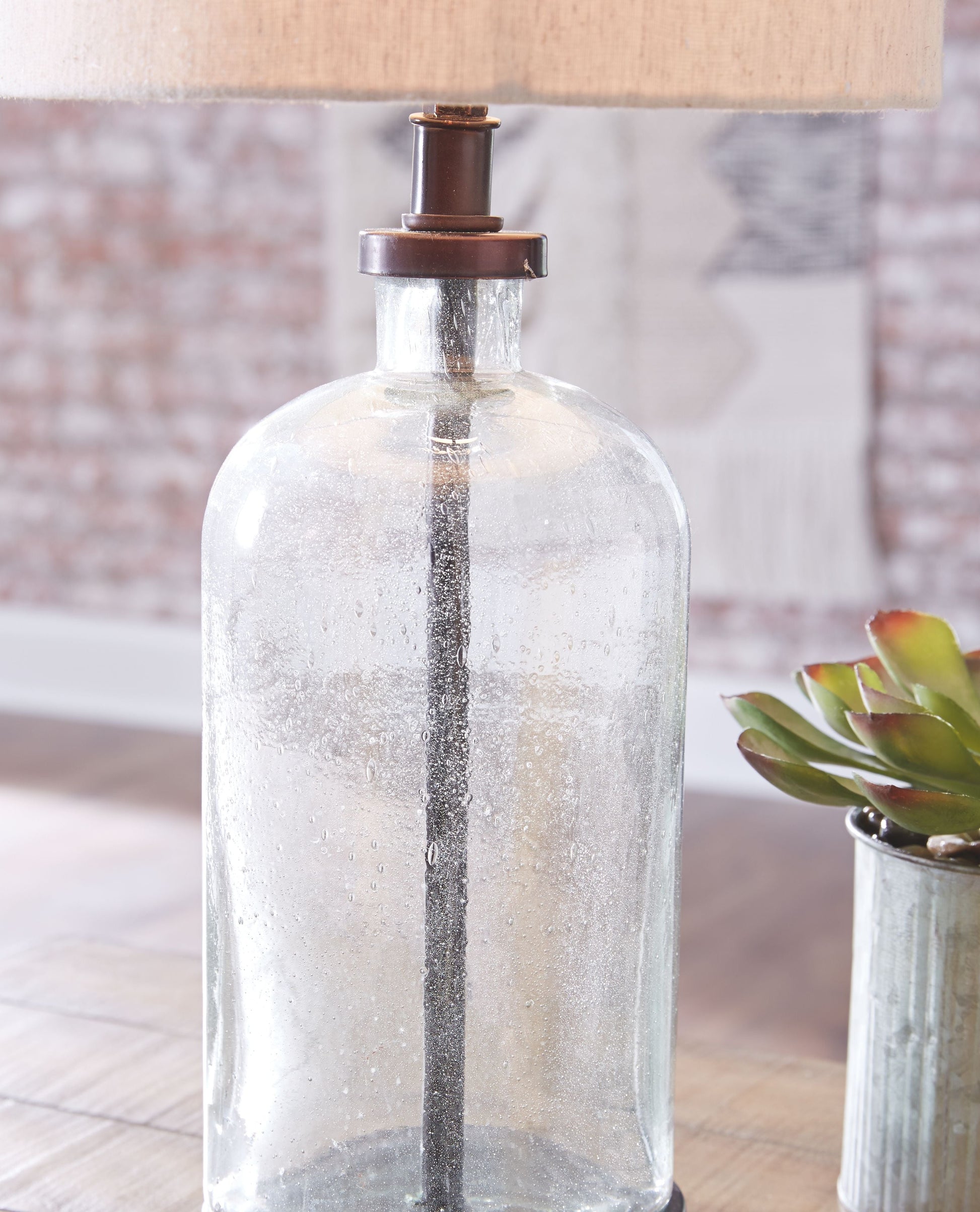 Ashley Furniture Bandile - Clear / Bronze Finish - Glass Table Lamp | Meri Furniture