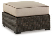 Signature Design by Ashley® Coastline Bay - Brown - Ottoman With Cushion | Meri Furniture